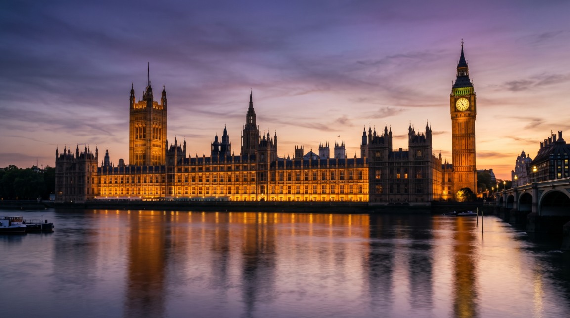 Palace of Westminster at dusk — Parliament as the seat of impeachment procedures and electoral remedies for constitutional breakdown